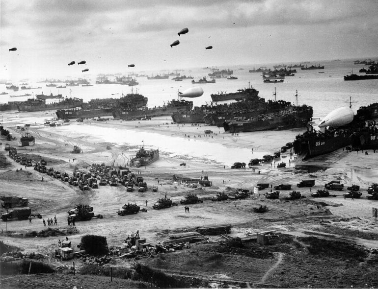 Landing ships putting cargo ashore on Omaha Beach, at low tide during the first days of the operation, mid-June, 1944. (WYDaily Courtesy National Archives)