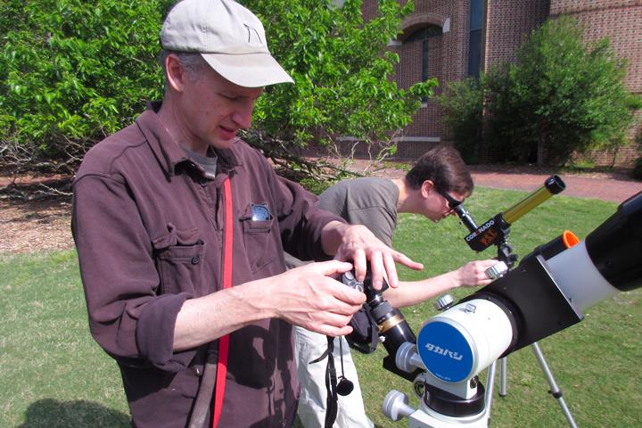 W&M physicist Joshua Erlich and lecturer Michael Gaynes look through the solar telescopes in May, 2016. (Photo by Joseph McClain/W&M News)