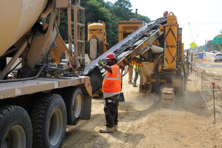 Crews pour the concrete footing for the median barrier, a quarter of a mile west of the Route 105 Fort Eustis interchange on I-64 for the widening project. (Courtesy VDOT.)