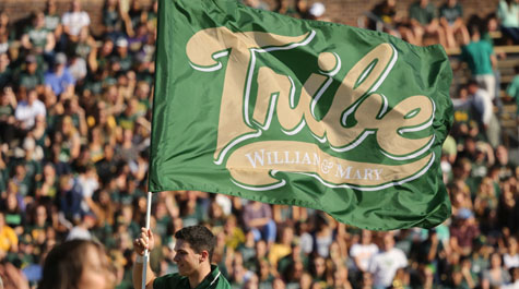 A member of the cheer team flies the Tribe flag during the football game. Photo by Stephen Salpukas