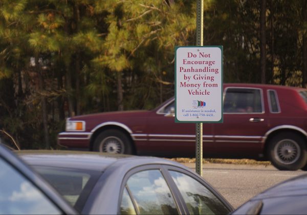 The signs tell motorists not give money to panhandlers, and a phone number at the bottom of each sign connects to the regional crisis housing hotline. (Steve Roberts, Jr./WYDaily)