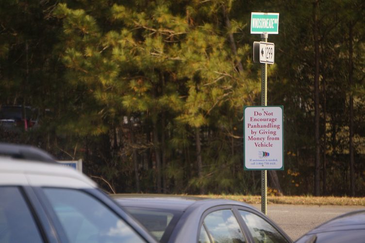The signs tell motorists not give money to panhandlers, and a phone number at the bottom of each sign connects to the regional crisis housing hotline. (Steve Roberts, Jr./WYDaily)