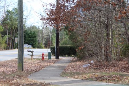 A sidewalk leads to nowhere outside Clara Byrd Baker Elementary School. Tyler Thomson's children spent several years riding the bus to Clara Byrd Baker Elementary School, even though it was a quarter-mile away. Now, the lack of pedestrian access might change. (Sarah Fearing/WYDaily)