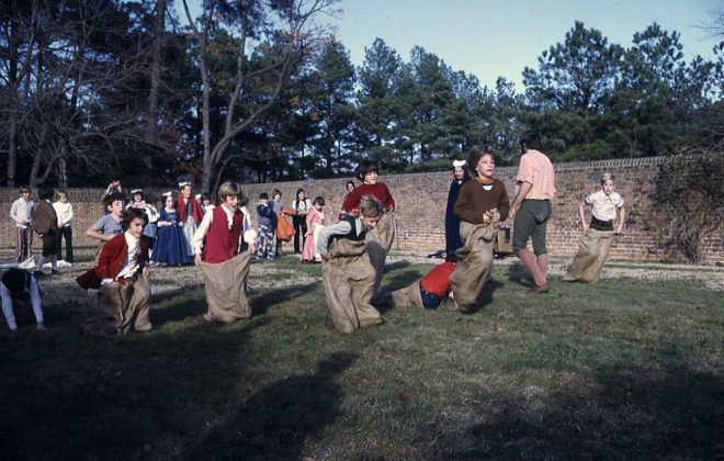 Sack racing, one of many Christmas activities offered during the 1969 holiday season at Colonial Williamsburg. (Stanton Becker Slide Collection, Rockefeller Library Visual Resources)