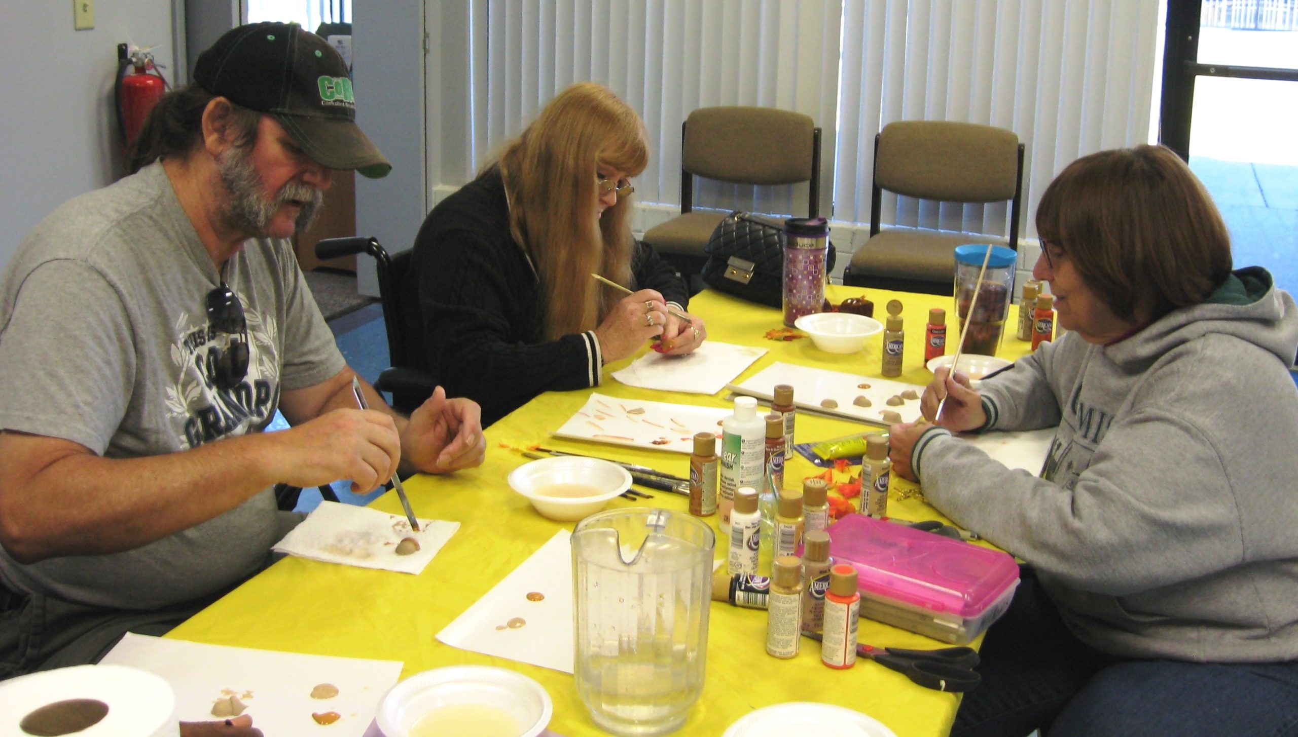 Craft Facilitator Kathleen Wahl helps Senior Center of York patrons to paint various objects. The next painting craft at the center will take place on Monday, January 22, at 10 a.m. Please call 757-890-3444 to register for this program and for more information on other events at the center. (Photo courtesy of York Senior Center)