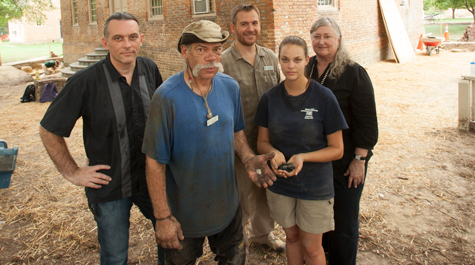 A photo from the 2011 excavation around the Brafferton shows Pamunkey tribal members Jeff Brown and Ashley Adkins Spivey (front) with relics dating to the time of the Indian School at William & Mary. (Courtesy photo/Stephen Salpukas
