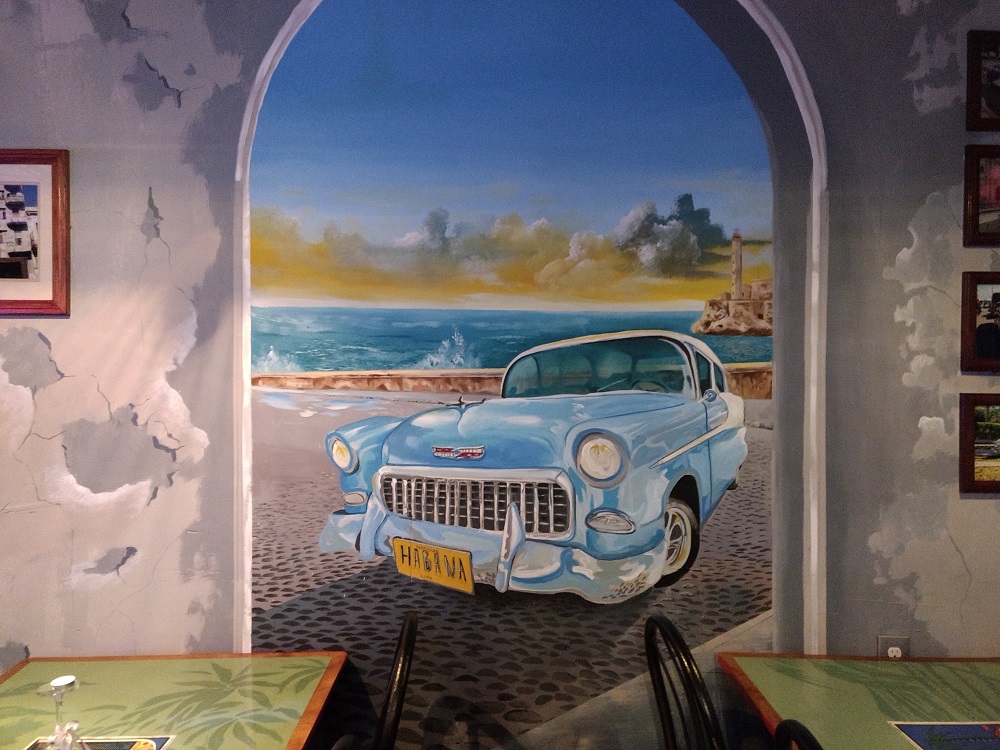 Lorenzo's artwork lines the walls in his new cafe. (Andrew Harris/WYDaily)