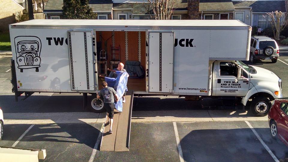 Two Men and a Truck employees load furniture onto a a moving truck. (Courtesy Stephen Milne/Two Men and a Truck)