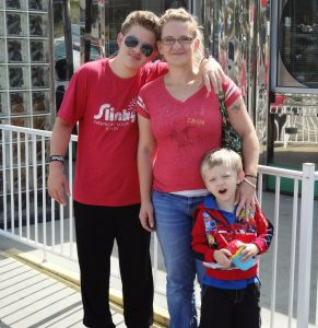 Austin Baxley poses with his younger brother, who is now 10 years old, and his mother in an undated photo. Crystal VanValkenburg has spent two years in courtrooms as prosecutors work to convict three people accused of participating in the murder of her son, Austin Baxley. (Courtesy photo/Crystal VanValkenburg)