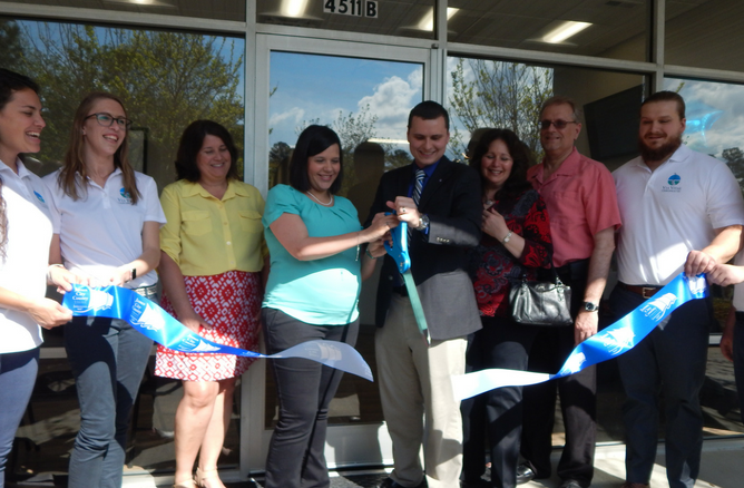 Dr. Brandon Babin and Heather Babin cut the ribbon for their new office, Via Vitae Chiropractic. (Courtesy photo/James City County)