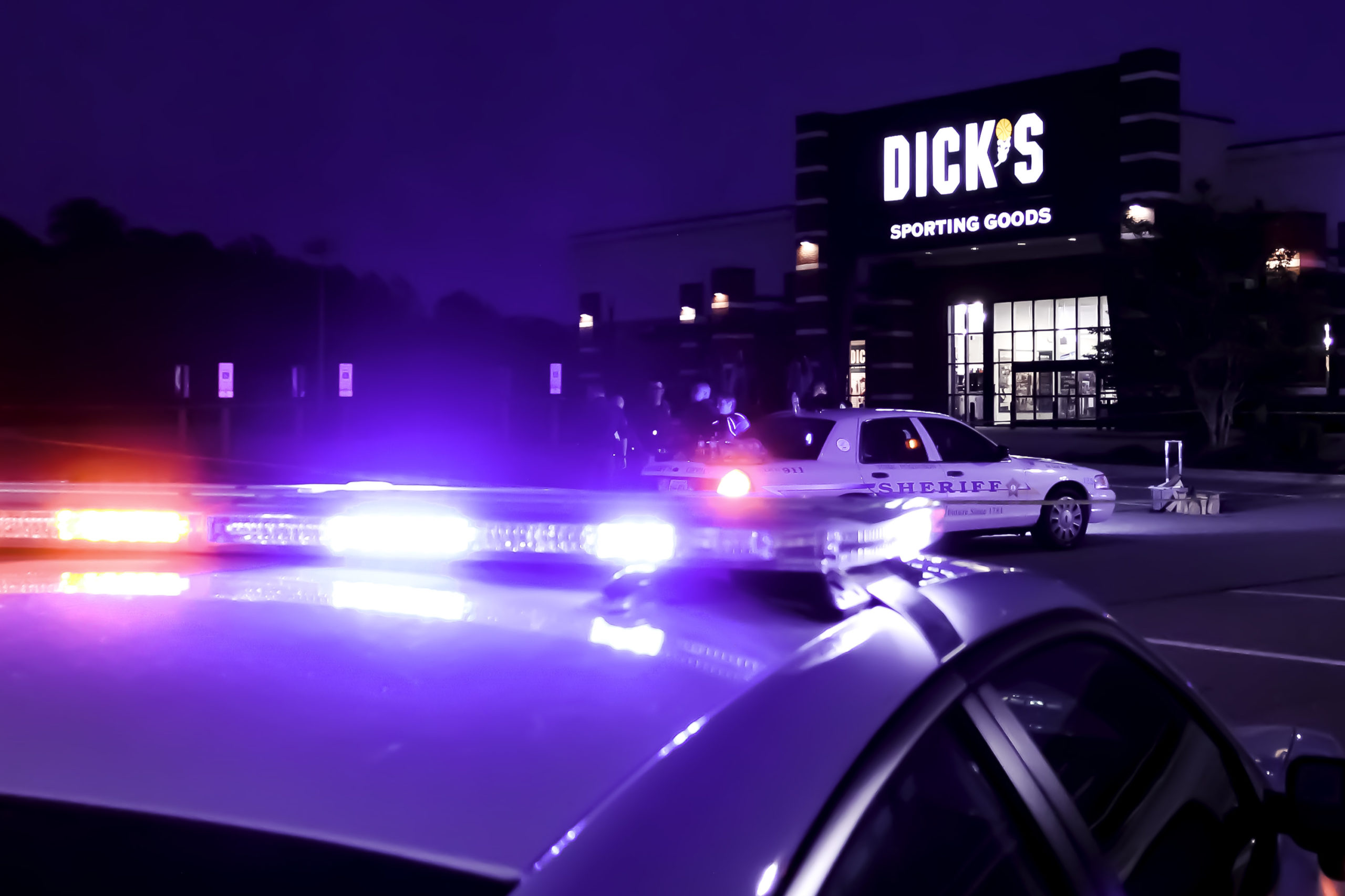 Members of the York-Poquoson Sheriff's Office investigate an apparent suicide Friday outside the Dick's Sporting Goods store in the Marquis Shopping Center. (Bryan DeVasher/WYDaily)