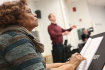 Composer Jeraldine Herbison concentrates on fine-tuning as visiting director of choirs Miles Canaday directs a choir rehearsal of the song she wrote. (Photo by Stephen Salpukas/W&M)