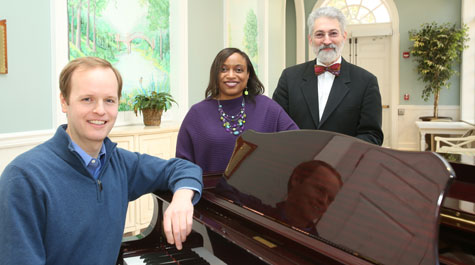 From left, visiting director of choirs Miles Canaday, associate professor of biology and 50th committee member Shantá D. Hinton and director of choirs James Armstrong worked together to have a song commissioned for the 50th commemoration of William & Mary's first African-American residential students and prepared for a first performance by the W&M Choir at commencement. (Photo by Stephen Salpukas/W&M)
