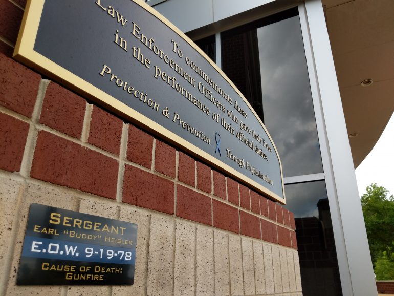A memorial for Sgt. Earl Heisler, a James City County Police officer who was killed in 1978, stands in front of the law enforcement center. (WYDaily/Sarah Fearing)