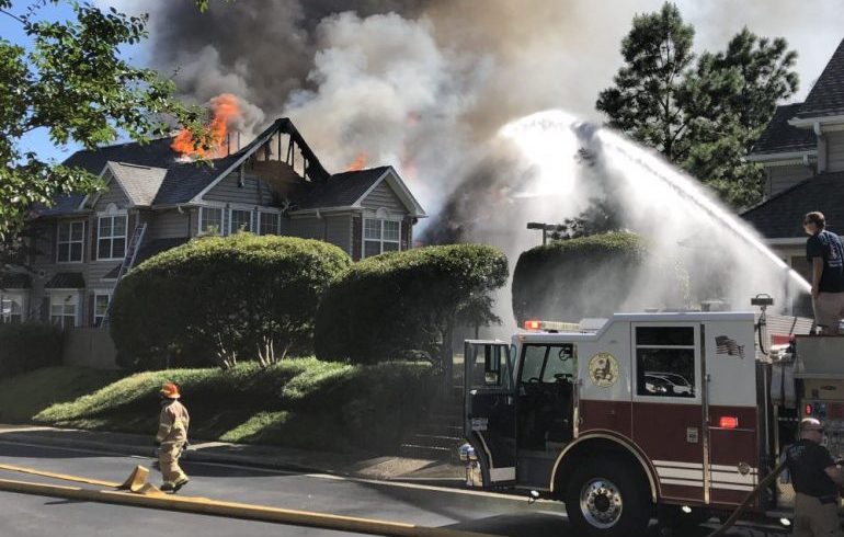 Firefighters battle a blaze after a helicopter crashed into a 10-unit townhome building Sunday, July 8, 2018, in the Bristol Commons complex in Williamsburg. (WYDaily file)
