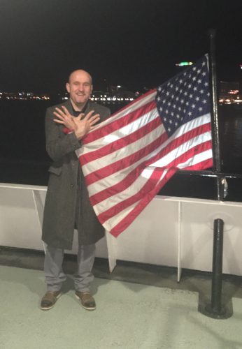 Ylber Zelli shows his pride for both his home and new country by representing Albania with the crossed hands while holding an American flag. This year will be Zelli's first celebrating the Fourth of July as an American citizen. (WYDaily/Courtesy of Ylber Zelli)