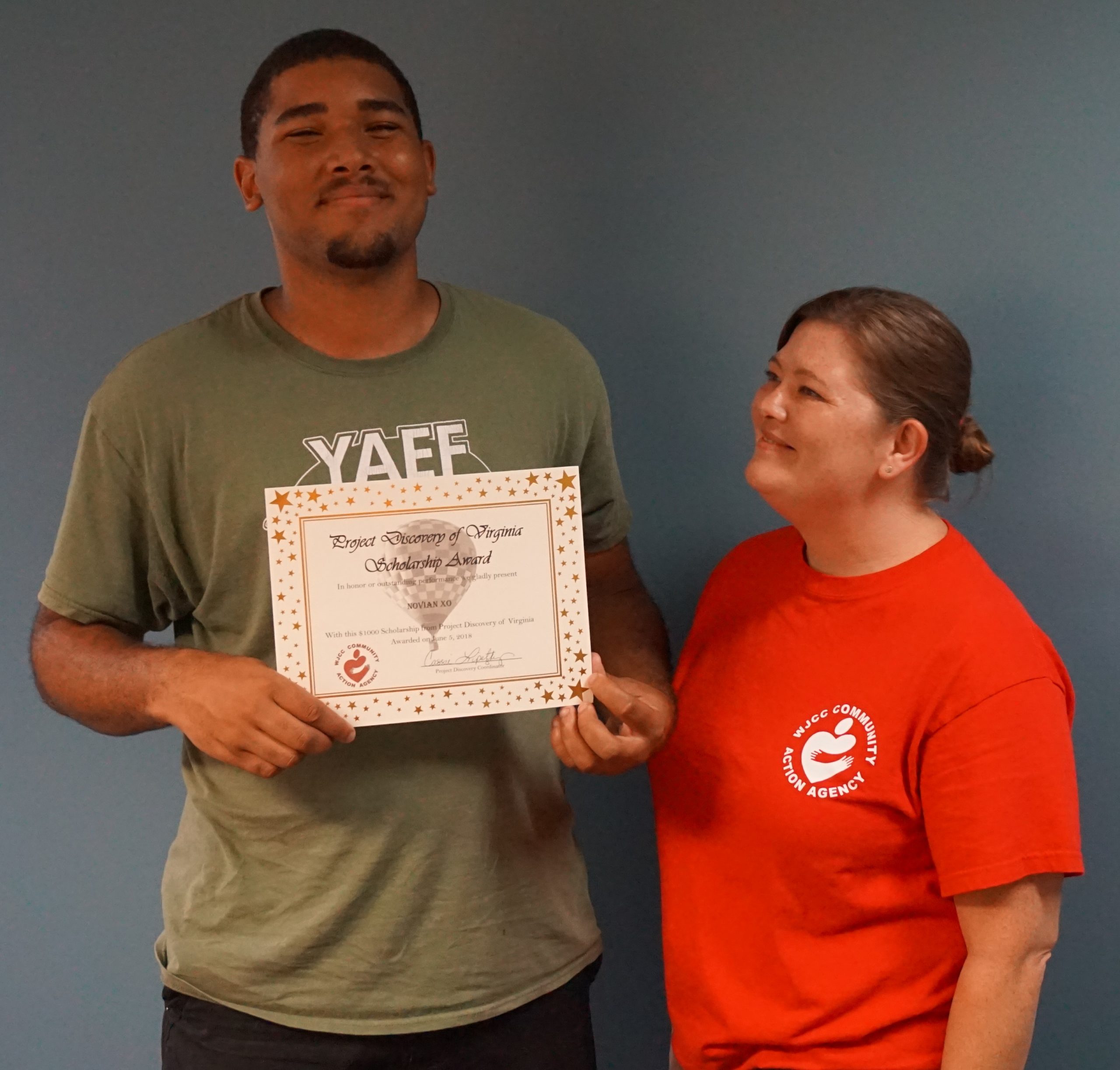 Novian XO receives his scholarship with Cassie Lipetzky, Project Discovery Coordinator. (WYDaily/Williamsburg-James City County Community Action Agency)