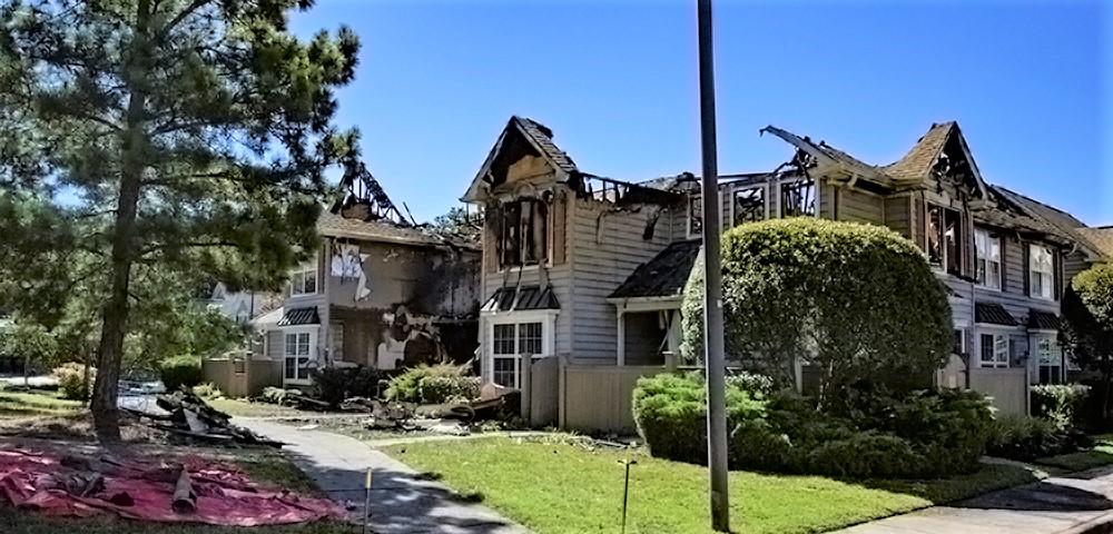A 10-unit condo building has been condemned after a helicopter crashed into it Sunday, July 8, 2018, in the Bristol Commons complex in Williamsburg. Two people died in the crash and resulting fire. (WYDaily/Bryan DeVasher)