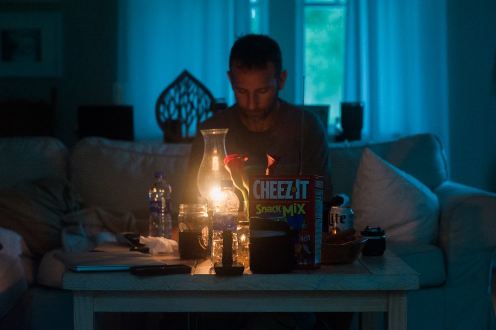 Adam Priest sits at a home on Princess Street in the Carolina Heights neighborhood east of downtown Wilmington as Hurricane Florence made landfall Friday. Priest evacuated his home on Carolina Beach on Wednesday. (Port City Daily photo | Mark Darrough)