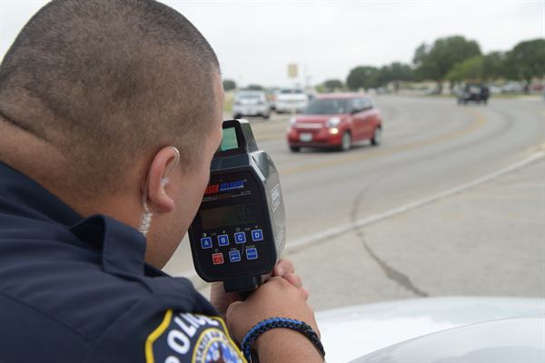 A police officer using a radar gun to enforce the speed limit. (WYDaily/ Courtesy U.S. Air Force)