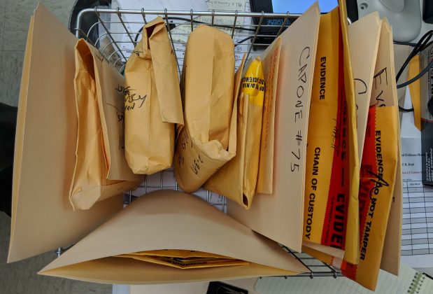 A basket full of evidence at the Williamsburg Police Department contains various items, including several VHS tapes. (WYDaily/Sarah Fearing)