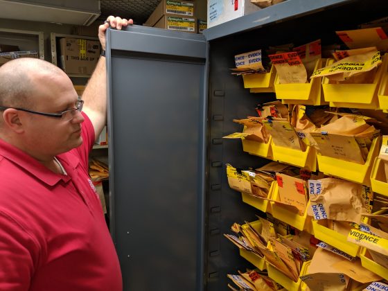 Lt. Brian Carlsen looks into an evidence cabinet containing illicit drugs. (WYDaily/Sarah Fearing)