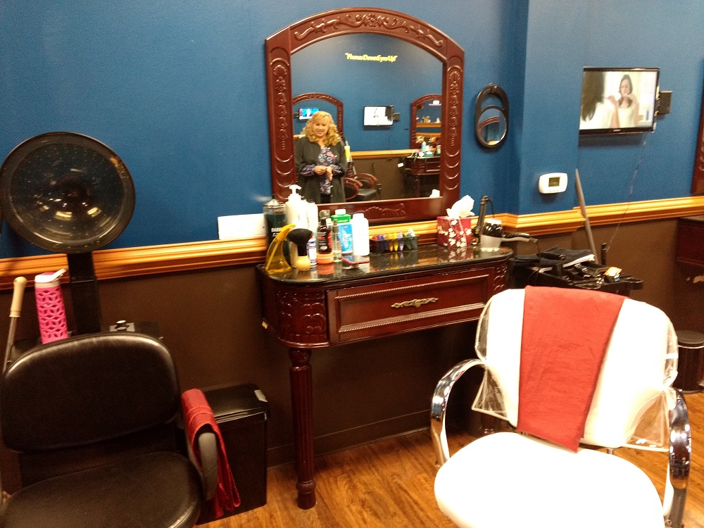 Mia Rothwell, seen in the reflection, has moved her hair salon into Duke's Barber Shop in Norge after her previous location was destroyed in a fire. (WYDaily/ Andrew Harris)