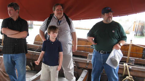 Visiting Professor of English Kevin Kritsch (left), traveling companions Beau Carr (adult), Ned Carr and Devin Herrod listen to a crew member talk about the Viking ship Draken Harald Hårfagre during a visit to Cape Charles before deciding later to take students to Norfolk. (WYDaily/Courtesy Suzanne Hagedorn)