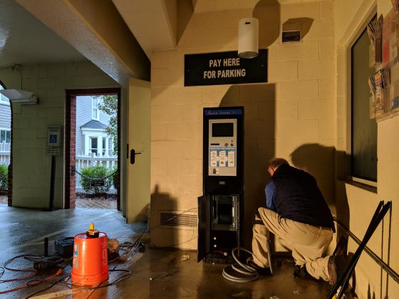 A city staff member installed a new pay station in the Prince George Parking Garage Thursday. (WYDaily/Sarah Fearing)