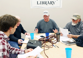 Local waterman J.C. Hudgins (C) talks with VIMS graduate student Jim DelBene (L) during a focus group to develop his survey. (Southside Daily/A. Devlin/VASG)