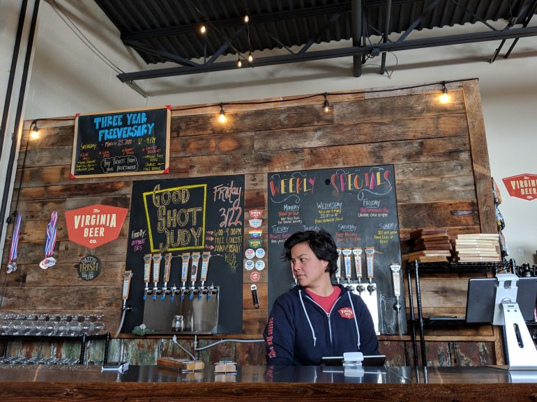 Taproom Manager Luci Legaspi stands behind the bar at Virginia Beer Co. on March 22, 2019. (WYDaily/Sarah Fearing)