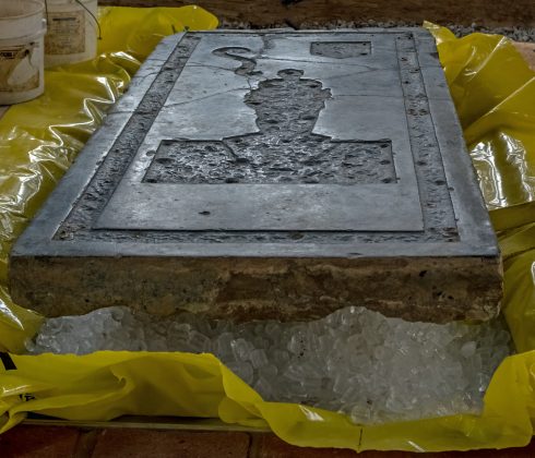The Knight's Tombstone sits atop a mound of ice. As the ice melted Tuesday, the stone settled into its final home in the floor of the Memorial Church. (WYDaily/Courtesy of Jamestown Rediscovery (Preservation Virginia))