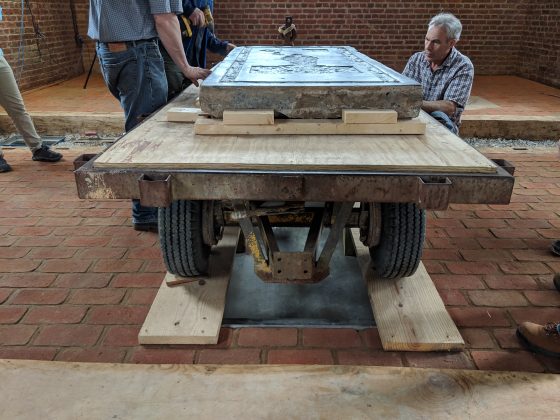 Left to right: Michael Lavin, David Givens and Jonathan Appell look over the Knight's Tombstone after it was wheeled into the Memorial Church Tuesday afternoon. (WYDaily/Sarah Fearing)