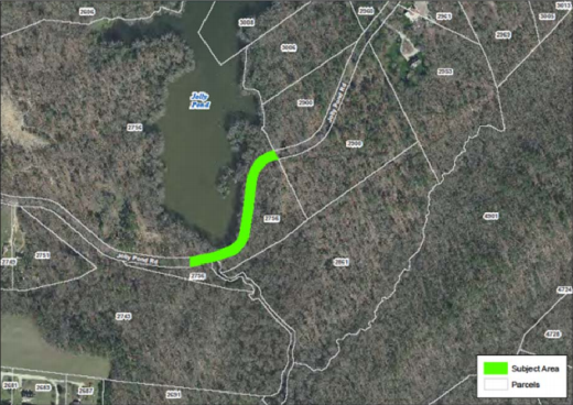 In recent years, Jolly Pond Road over the dam has gradually deteriorated, culminating in a void developing beneath the roadway and rendering part of it unsafe for travel. (WYDaily/Courtesy of James City County)