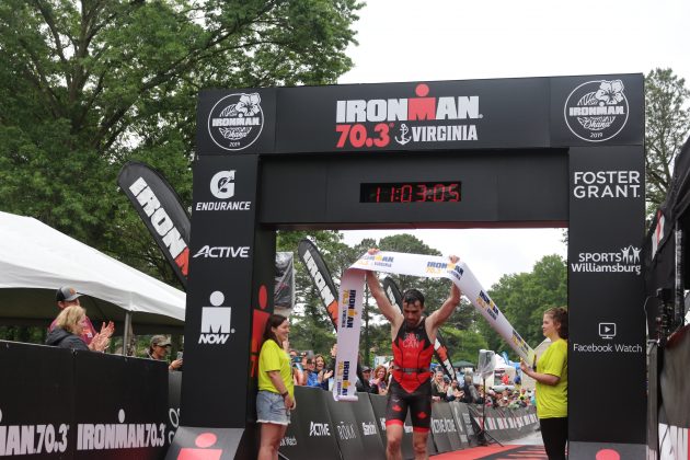 Philippe Tremblay, 26, of Montreal, crosses the finish line as the first male finisher in the Ironman 70.3 Virginia Triathlon Sunday. (WYDaily/Alexa Doiron)
