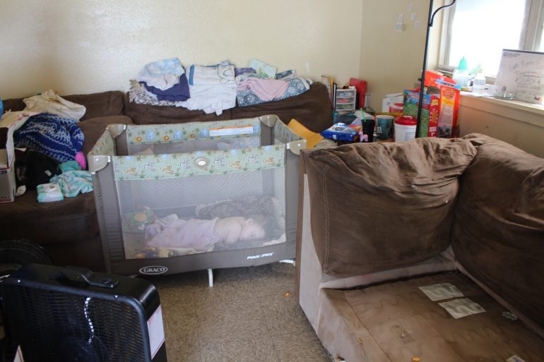 Zane, 9 months sleeps in his playpen with two fans in the Snack's living room. The family has not had air conditioning for over a week (WYDaily/ Julia Marsigliano)