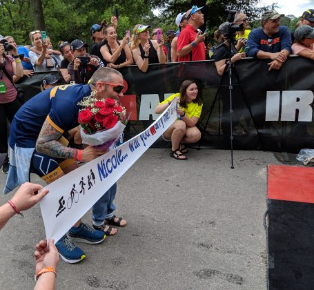 NYPD Officer Tim Stamm proposed to his girlfriend, Nicole Sweeney, as she crossed the finish line at Sunday's Ironman 70.3 half-triathlon. (WYDaily/Sarah Fearing)
