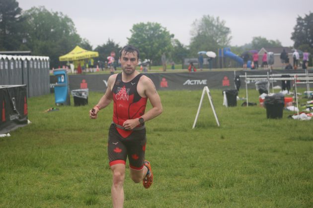 Philippe Tremblay takes a corner after finishing the bike portion of the half-triathlon Sunday. (WYDaily/Alexa Doiron)