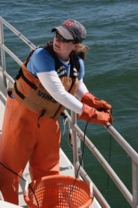 Alison Smith deploys a sensor to record water temperature, salinity, and dissolved oxygen readings during the Blue Crab Winter Dredge Survey. The data are compared to dredge survey results to better understand blue crab distribution, habitat use, and behavior. (Southside Daily/VIMS)