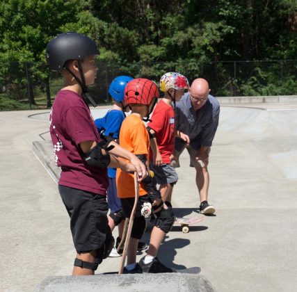 Max Pfannebecker with his son and skate clinic coach, Locke Pfannebecker, teaching some of the weekend's young attendees. (WYDaily Photo/Kellie Thomas)