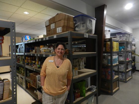 Shannon Woloszynowski, executive director at Williamsburg House of Mercy, standing in the food pantry. (WYDaily Photo/Benjamin West)