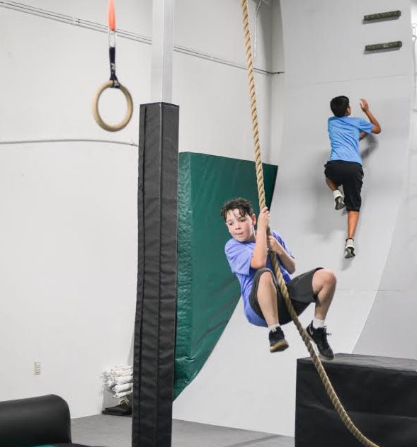 Anderson Morrow swings into action on a hanging rope at Chain Breakers Warrior Academy. (WYDaily/Courtesy of Mary Rothwell Photography)