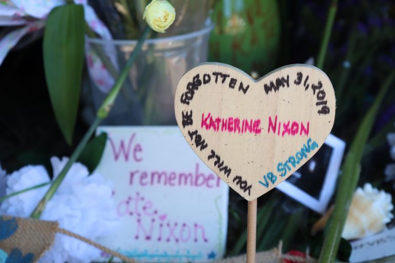 Virginia Beach residents visit a memorial outside of Building 11 dedicated to the 12 victims lost in the Municipal Center shooting. (WYDaily/Lucretia Cunningham)