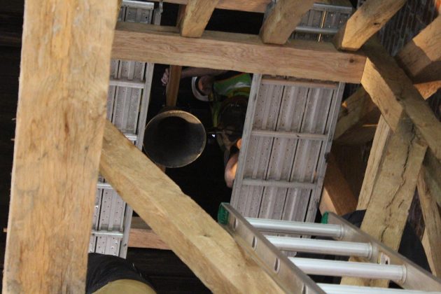 A bell replicating an original version possibly dating back to 1608 was hoisted into the belfry of a timber frame church exhibit Tuesday July 16, 2019. (WYDaily/Sarah Fearing)