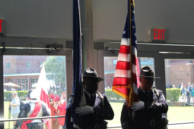 Virginia Capitol Police carry in flags to an event tent where President Donald Trump spoke in honor of 400 years of democracy in America Tuesday. (WYDaily/Alexa Doiron)