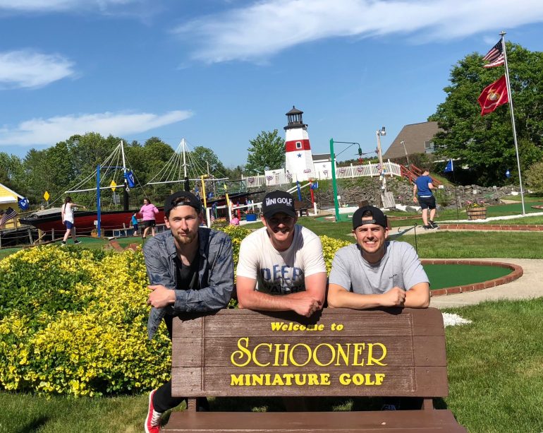 Anthony Haakenson. Michael Babcock and Alex Cram pose for a photo while on a mini golf tournament trip in Maine. (WYDaily/Courtesy of Michael Babcock)