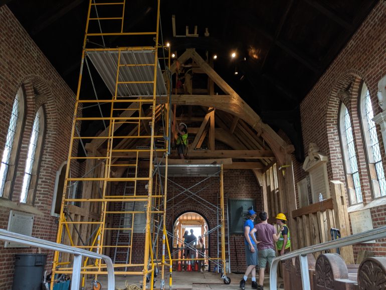 Black Creek Workshop crews construct the timber frame of a 1617 church within the walls of Jamestown's Memorial Church on Tuesday. (WYDaily/Sarah Fearing)