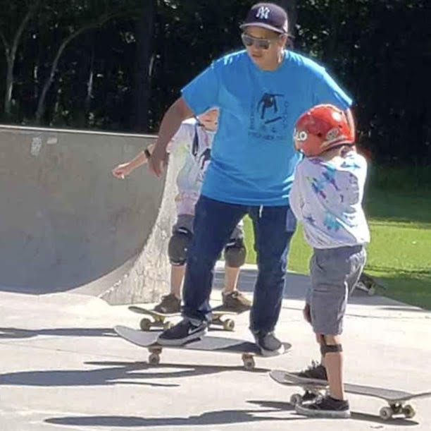 Professional skateboarder Jaime Reyes teaching young Declan White at a recent skate camp in Gloucester. After decades traveling the world (which she still does), Reyes has settled in Williamsburg, and soon plans to teach at free, summer-long skate events in town. (WYDaily Photo/Max Pfannebecker)