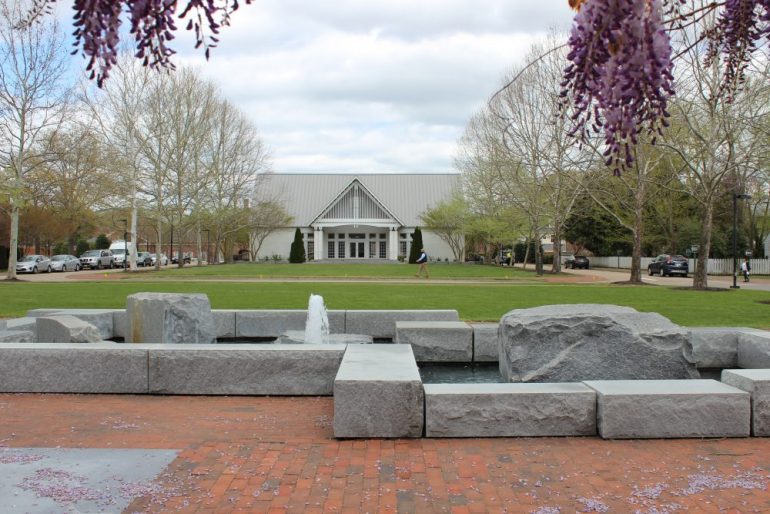 A view of City Square from under a wisteria-covered trellis. North Boundary Street cuts through the middle of the park between the Community Building lawn and the green space between the Stryker Center and Williamsburg Regional Library. (WYDaily/Courtesy City of Williamsburg)