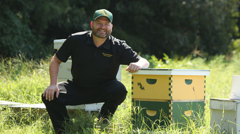Sadler Center Court Operation Manager Stephen Moyer shows off William & Mary's honey bee hives that Dining Services is cultivating at KelRae Farm. (WYDaily/Courtesy of Stephen Salpukas)